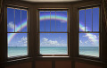 窓から虹と海